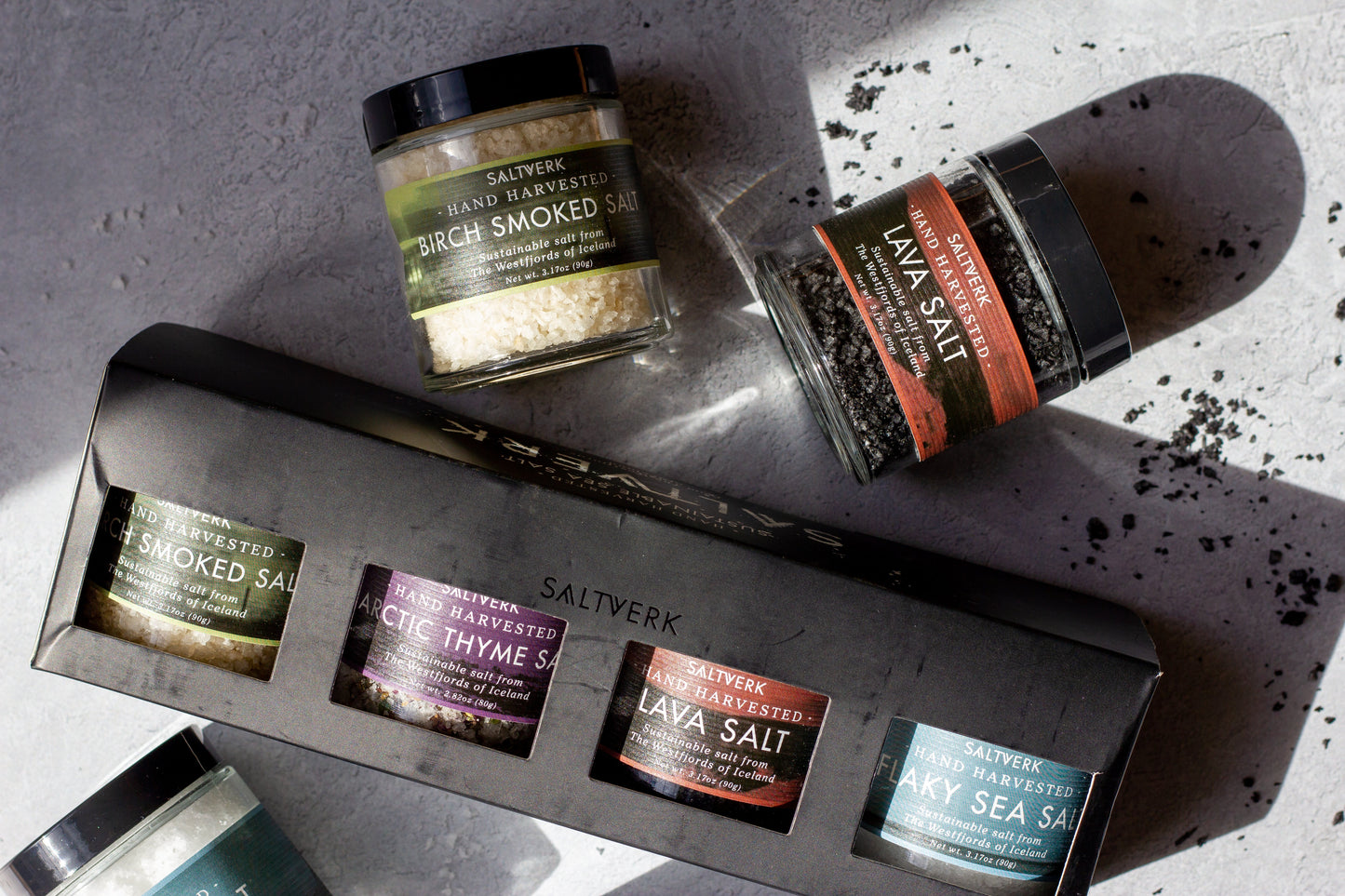 Collection of Saltverk salt products on a textured surface